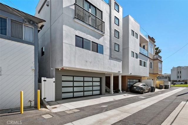 view of building exterior featuring a residential view and an attached garage