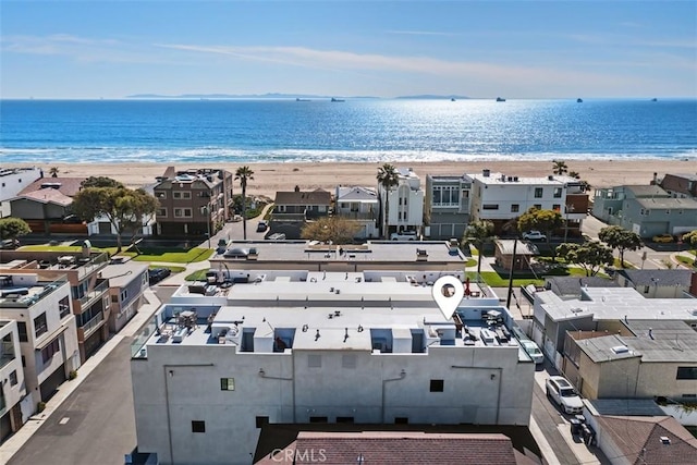 birds eye view of property with a view of the beach and a water view