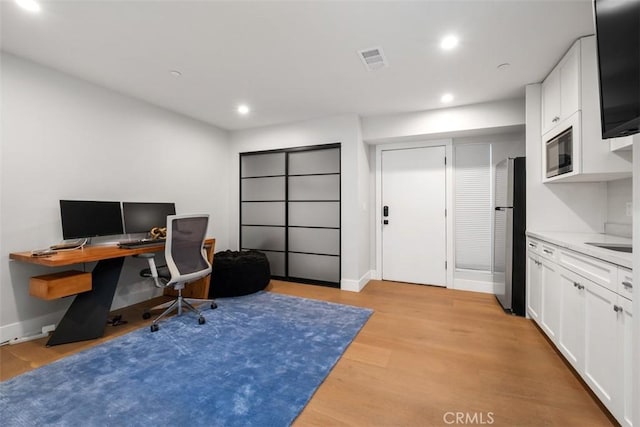 office area featuring recessed lighting, baseboards, light wood-style floors, and visible vents
