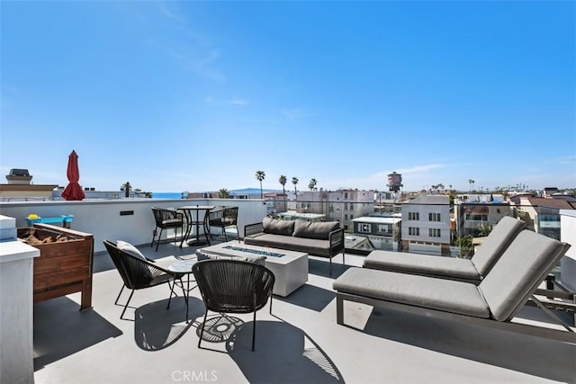 view of patio / terrace with an outdoor living space with a fire pit