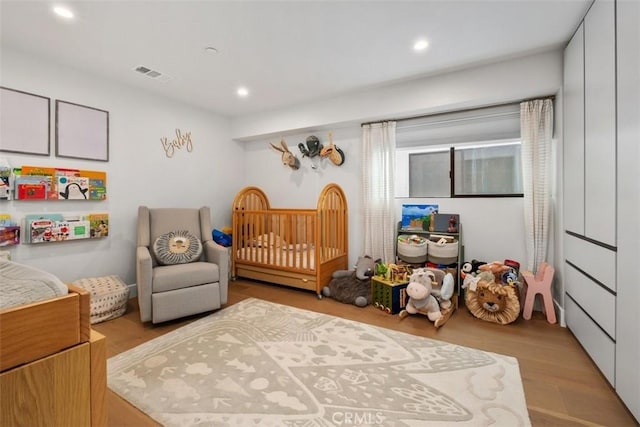 bedroom featuring visible vents, recessed lighting, and wood finished floors