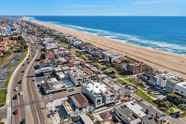 drone / aerial view featuring a water view and a beach view
