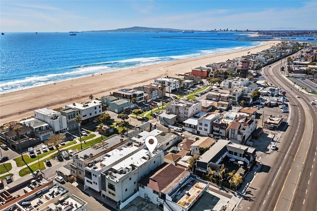 birds eye view of property featuring a water view and a view of the beach
