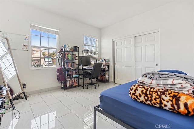 25445 Clovelly Ct, Moreno Valley, CA 92553 - bedroom featuring tile patterned floors, baseboards, and a closet