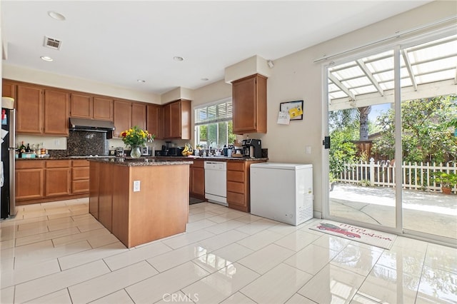 25445 Clovelly Ct, Moreno Valley, CA 92553 - kitchen featuring visible vents, dishwasher, under cabinet range hood, a center island, and fridge