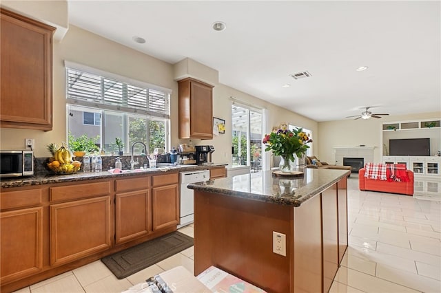 25445 Clovelly Ct, Moreno Valley, CA 92553 - kitchen featuring stainless steel microwave, ceiling fan, visible vents, white dishwasher, and a fireplace