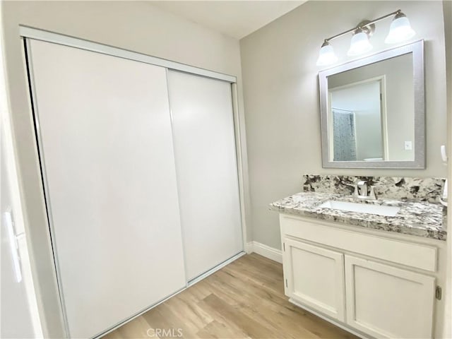11031 Victor Ave, Hesperia, CA 92345 - bathroom featuring wood finished floors, vanity, and baseboards