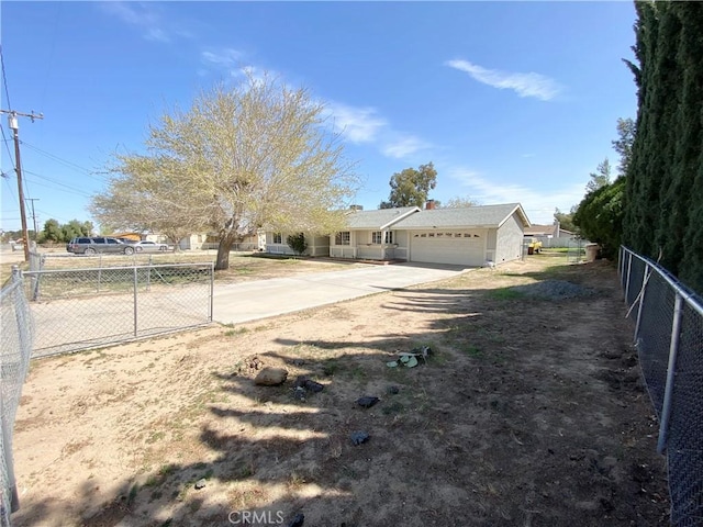 11031 Victor Ave, Hesperia, CA 92345 - view of yard featuring an attached garage, concrete driveway, and fence
