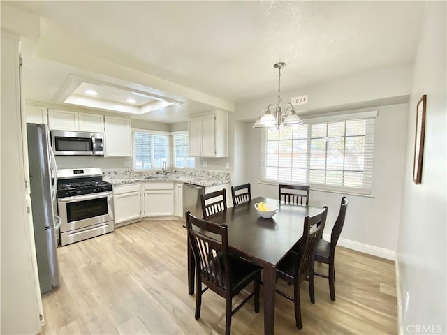 11031 Victor Ave, Hesperia, CA 92345 - dining room featuring a raised ceiling, light wood-style floors, a chandelier, baseboards, and recessed lighting