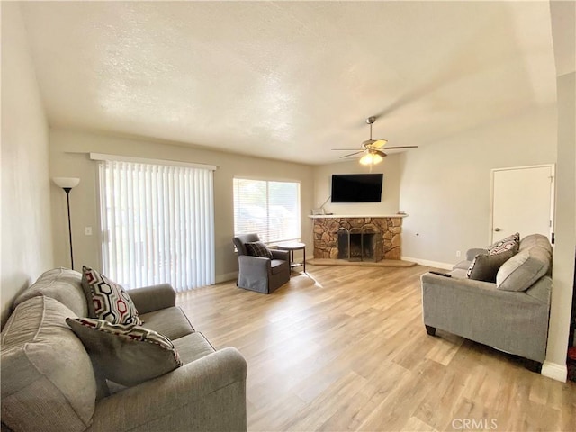 11031 Victor Ave, Hesperia, CA 92345 - living area with a ceiling fan, light wood-type flooring, a fireplace, and baseboards