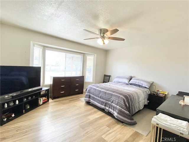 11031 Victor Ave, Hesperia, CA 92345 - bedroom featuring light wood-type flooring, ceiling fan, and a textured ceiling
