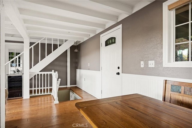 475 Woodsey Rd, Crestline, CA 92325 - unfurnished dining area with beam ceiling, stairway, hardwood / wood-style flooring, wainscoting, and a textured wall