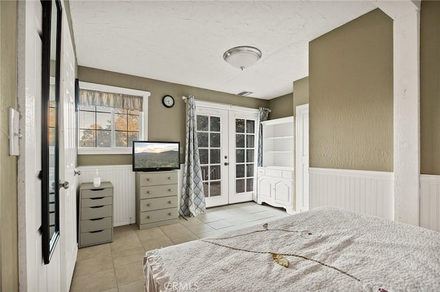 475 Woodsey Rd, Crestline, CA 92325 - tiled bedroom with a wainscoted wall, access to exterior, french doors, and a textured ceiling