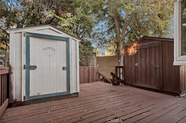 475 Woodsey Rd, Crestline, CA 92325 - deck featuring an outbuilding, a shed, and fence