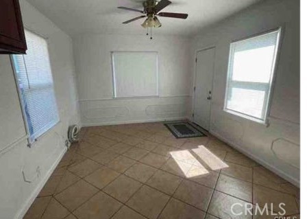 1640 Alameda St, Pomona, CA 91768 - tiled empty room with baseboards and a ceiling fan
