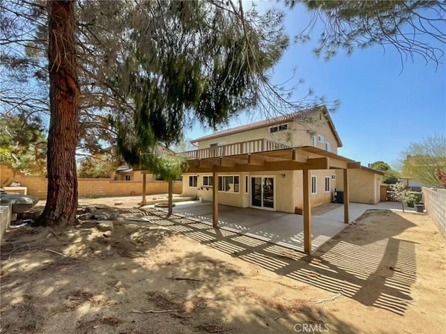 back of property with stucco siding, a fenced backyard, and a patio area