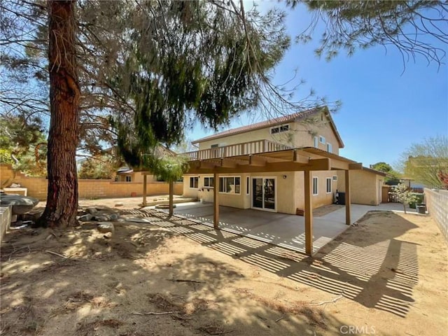 43856 Windsor Pl, Lancaster, CA 93536 - rear view of property with stucco siding, a fenced backyard, and a patio area