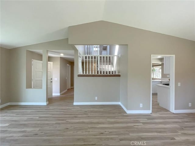 43856 Windsor Pl, Lancaster, CA 93536 - empty room with vaulted ceiling and light wood-style floors