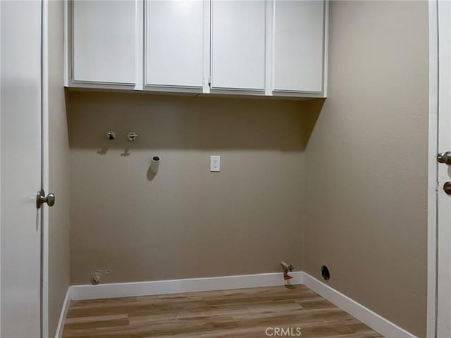 43856 Windsor Pl, Lancaster, CA 93536 - laundry room with gas dryer hookup, cabinet space, and light wood-style flooring