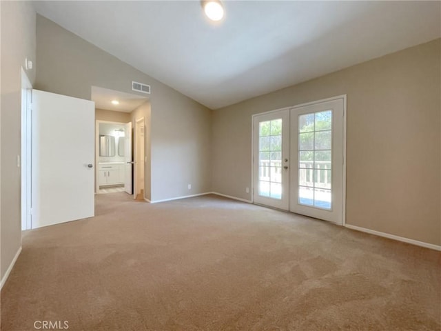43856 Windsor Pl, Lancaster, CA 93536 - spare room with vaulted ceiling, light colored carpet, and french doors