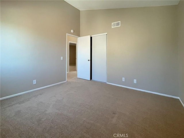 43856 Windsor Pl, Lancaster, CA 93536 - carpeted spare room featuring baseboards and high vaulted ceiling