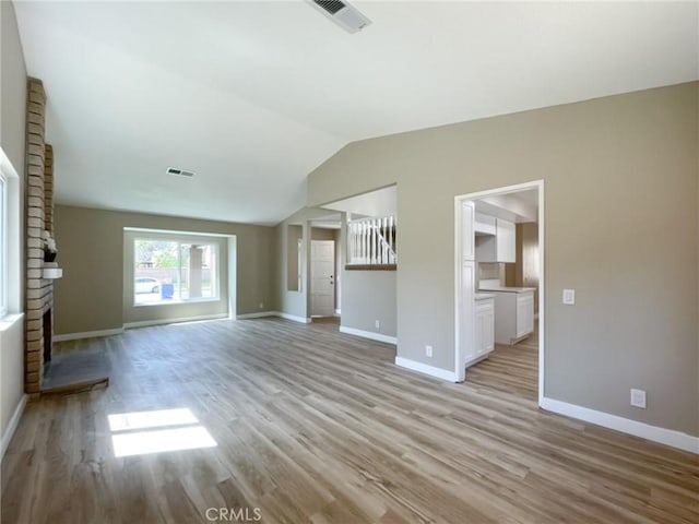 43856 Windsor Pl, Lancaster, CA 93536 - unfurnished living room featuring light wood-style flooring and lofted ceiling