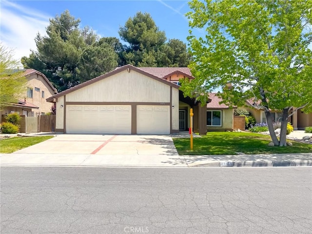 view of front of property with an attached garage, concrete driveway, a tile roof, and stucco siding