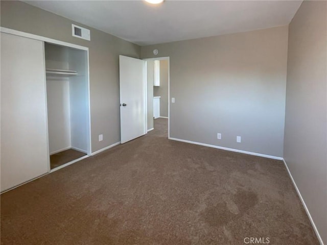 unfurnished bedroom featuring carpet flooring, a closet, and baseboards