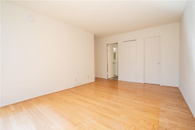 unfurnished bedroom featuring light wood-style floors