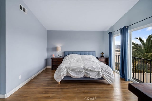 bedroom featuring vaulted ceiling, wood finished floors, access to outside, baseboards, and visible vents