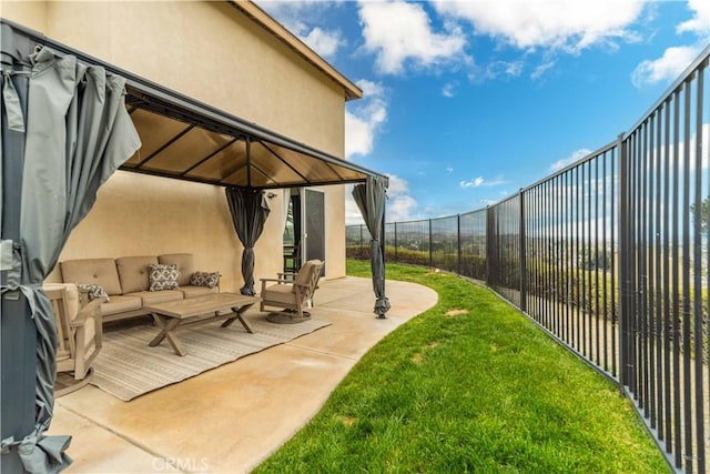 view of yard with an outdoor hangout area, a gazebo, fence, and a patio area
