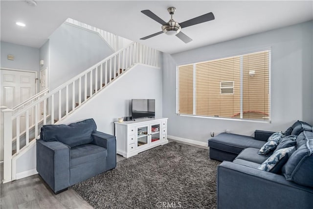 living room featuring stairway, wood finished floors, baseboards, ceiling fan, and recessed lighting