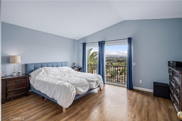 bedroom with baseboards, access to exterior, lofted ceiling, and dark wood finished floors