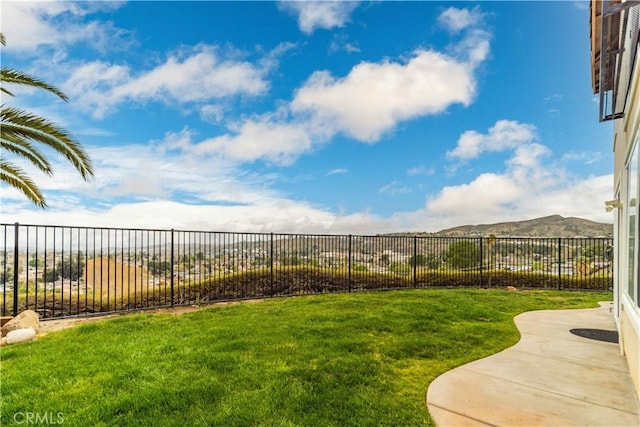 view of yard with fence and a mountain view