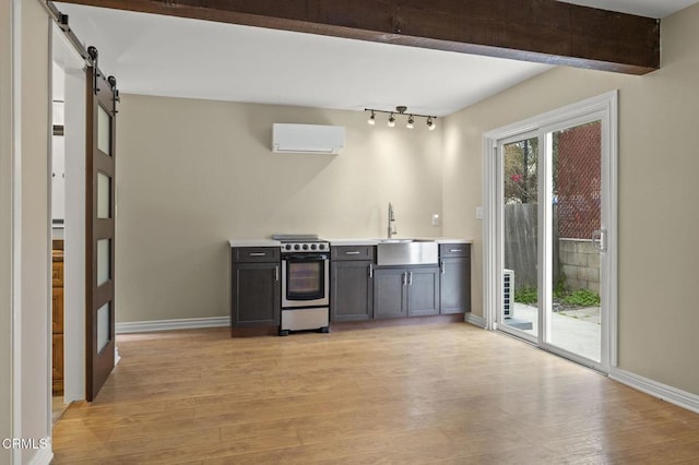 276 Highland Dr, Oxnard, CA 93035 - kitchen featuring stainless steel electric range oven, a wall mounted AC, light wood-type flooring, baseboards, and a sink