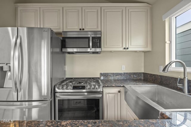 276 Highland Dr, Oxnard, CA 93035 - kitchen with stainless steel appliances, a sink, and dark stone counters
