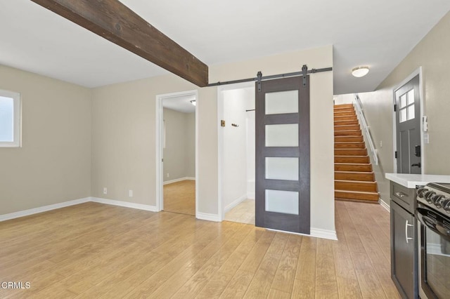 276 Highland Dr, Oxnard, CA 93035 - interior space featuring a barn door, black range with electric cooktop, light wood-type flooring, light countertops, and beamed ceiling