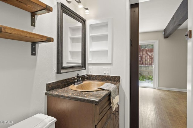 276 Highland Dr, Oxnard, CA 93035 - half bathroom featuring vanity, wood finished floors, toilet, and baseboards
