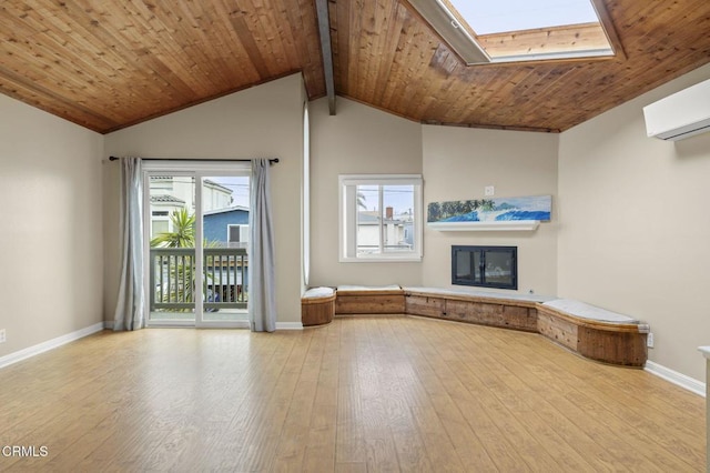 276 Highland Dr, Oxnard, CA 93035 - unfurnished living room with hardwood / wood-style flooring, baseboards, a glass covered fireplace, wooden ceiling, and a skylight