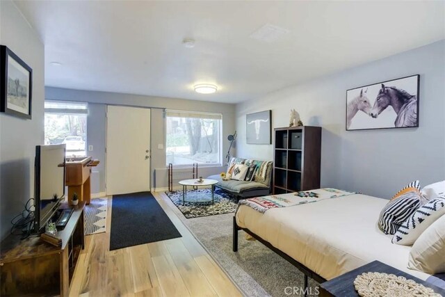 874 Fern Dr, Crestline, CA 92325 - bedroom with multiple windows and wood finished floors