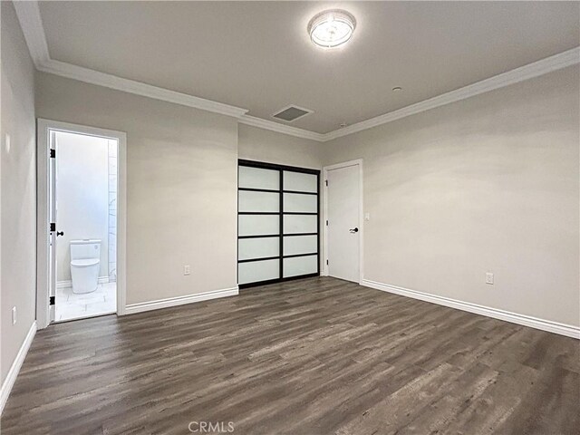 139 E Puente St, Covina, CA 91723 - unfurnished bedroom with ornamental molding, dark wood-style floors, baseboards, and connected bathroom