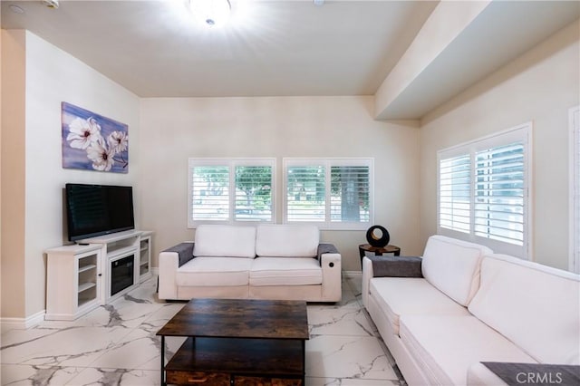 139 E Puente St, Covina, CA 91723 - living area featuring light marble finish floors, plenty of natural light, and baseboards