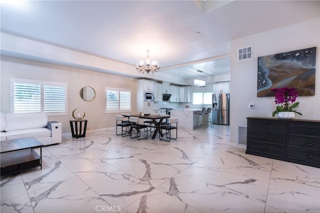 139 E Puente St, Covina, CA 91723 - dining room with a chandelier, baseboards, and light marble finish floors