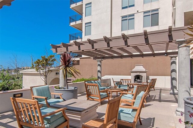 1021 Costa Pacifica Way Unit 2105, Oceanside, CA 92054 - view of patio / terrace with a pergola and an outdoor living space with a fireplace