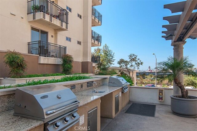 1021 Costa Pacifica Way Unit 2105, Oceanside, CA 92054 - view of patio with a sink and an outdoor kitchen