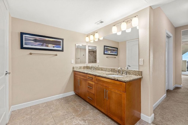 1021 Costa Pacifica Way Unit 2105, Oceanside, CA 92054 - bathroom featuring double vanity and baseboards