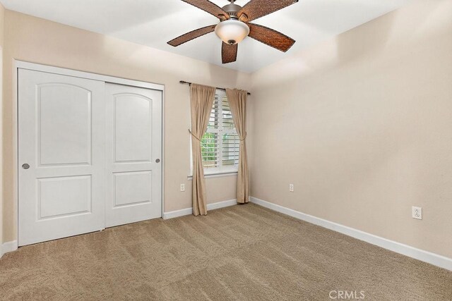 1021 Costa Pacifica Way Unit 2105, Oceanside, CA 92054 - unfurnished bedroom featuring light colored carpet, a closet, and a ceiling fan