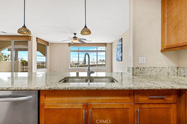 1021 Costa Pacifica Way Unit 2105, Oceanside, CA 92054 - kitchen with dishwasher, light stone countertops, and ceiling fan