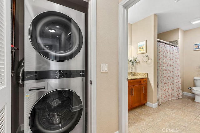 1021 Costa Pacifica Way Unit 2105, Oceanside, CA 92054 - washroom with stacked washer and clothes dryer and light tile patterned flooring