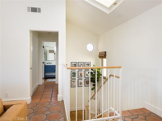535 E Walnut Ave Unit A, El Segundo, CA 90245 - hall with an upstairs landing, tile patterned floors, lofted ceiling, and a skylight